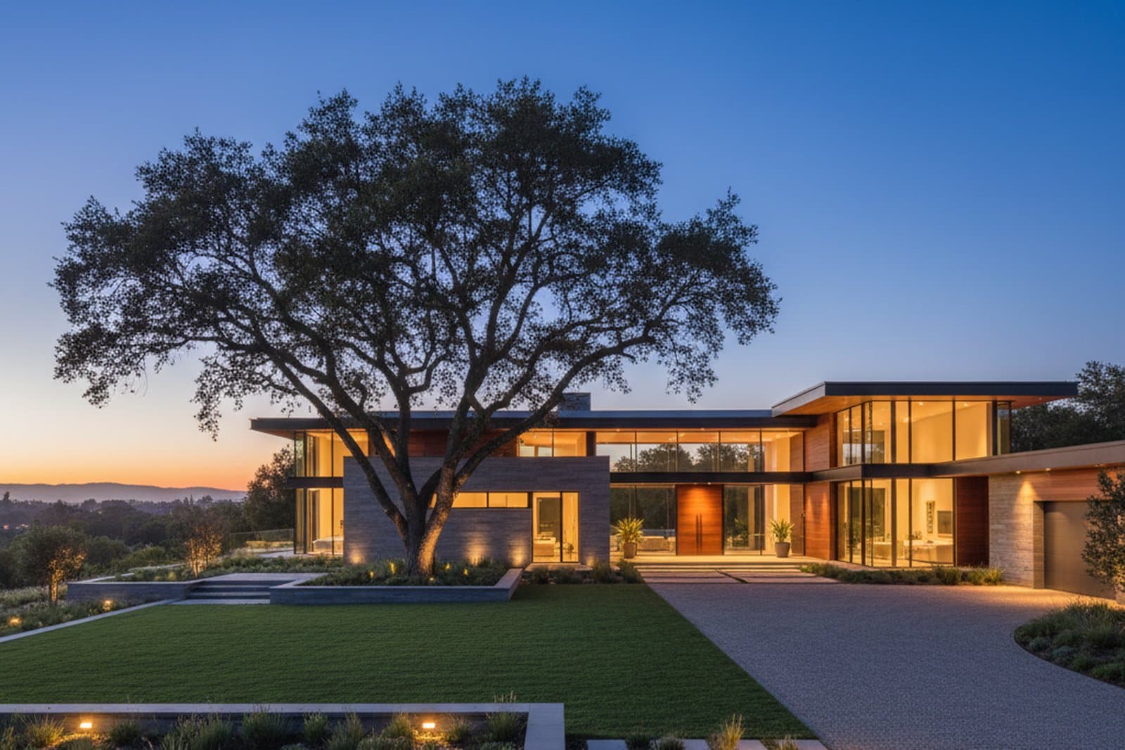 Contemporary Atherton estate at dusk — floor-to-ceiling glass and warm light
